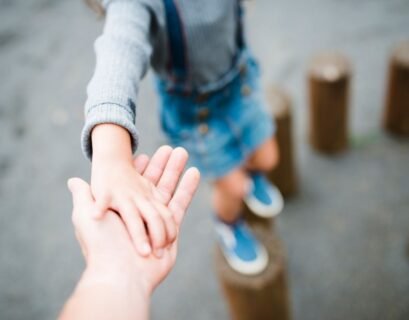 A Kid holding her fathers hand