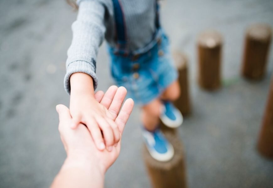 A Kid holding her fathers hand